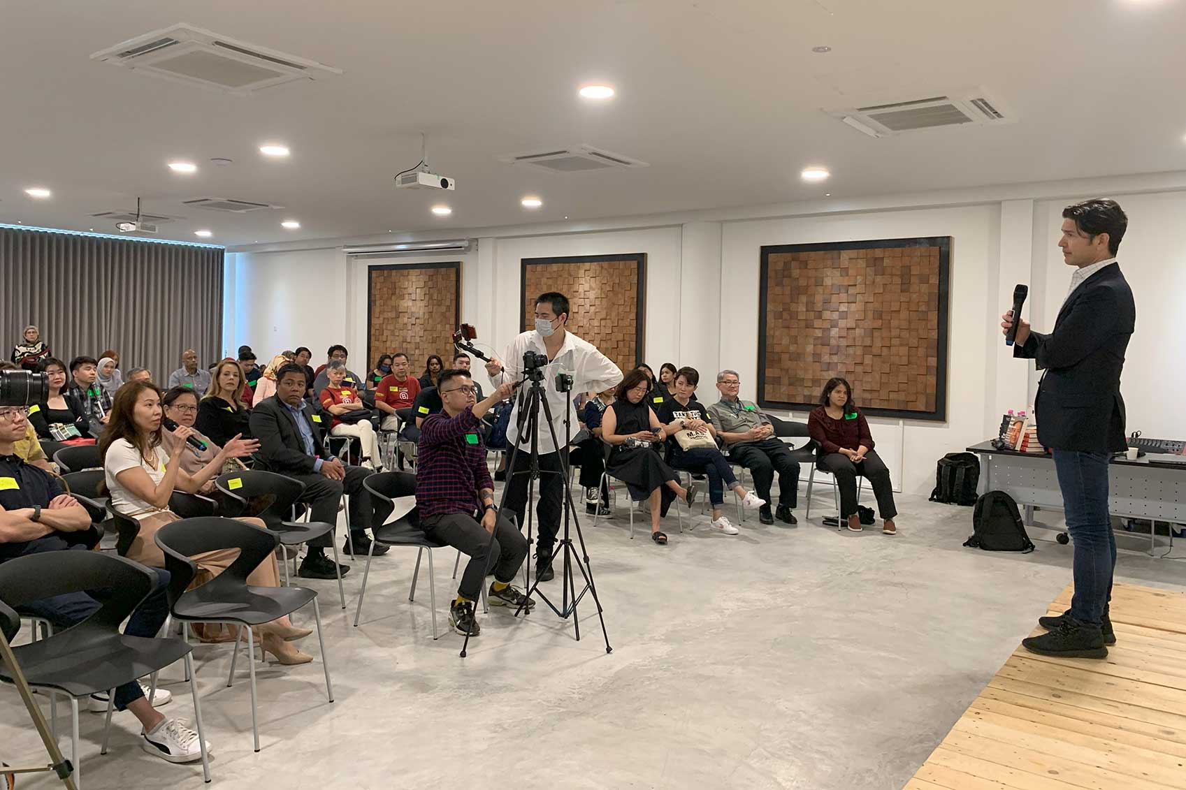 Audience attentively listening to a speaker at a seminar.